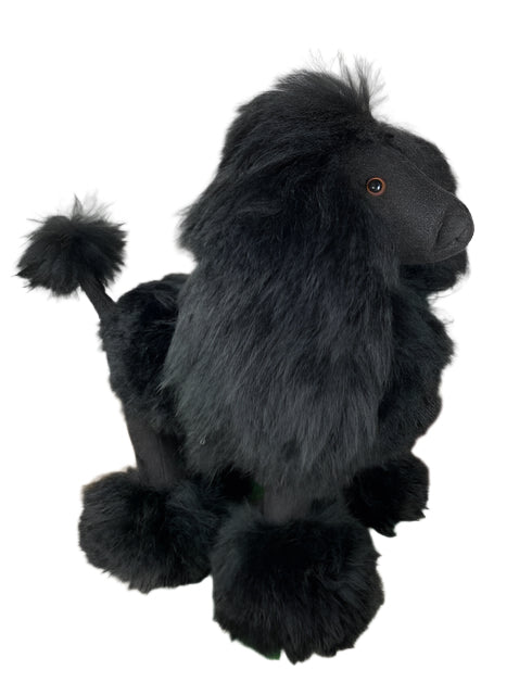 Black plush dog toy on a patterned rug