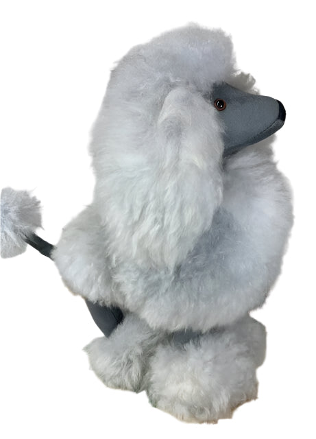 Plush toy poodle on a patterned rug